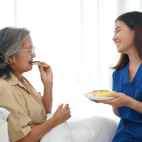 Caregiver feeding elderly