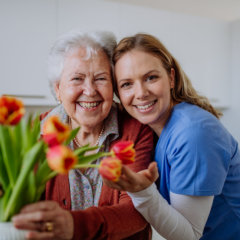 Caregiver hugging elderly
